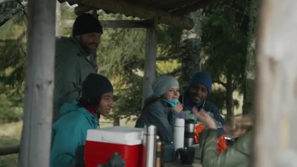 Hiking Buddies Rest Wooden Gazebo Diverse Tourists Sit Table Drink — Stock Video