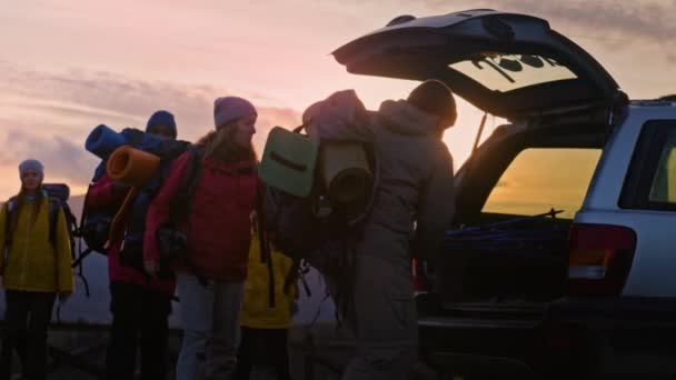 Группа Разнообразных Туристов Собирает Багажник Автомобиля Пешеходные Палки Рюкзаки Готовясь — стоковое видео