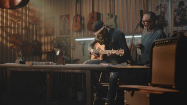 Müzisyen, şık bir garaj stüdyosunda metronomu dinleyerek gitar çalıyor. Olgun müzik öğretmeni sesi dinler ve insanlara müzik enstrümanı çalmayı öğretir. Duvarda el yapımı gitarlar asılı..