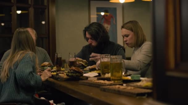 Skupina Přátel Mluví Jedí Hamburgery Občerstvení Popíjí Pivo Posezení Stylovém — Stock video