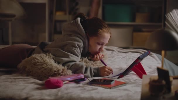 Молодая Девушка Лежит Дома Кровати Пишет Блокноте Занимается Онлайн Обучением — стоковое видео
