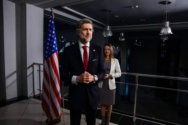 stock image President of the USA during press conference. Positive American politician waves his hand and poses for cameras after inspirational speech or interview with journalists for media and television news.