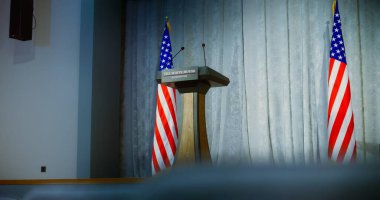 Speech tribune for President of the United States or government representative in the White House in press conference hall. Podium debate stand with microphones on stage. Backdrop with American flags. clipart