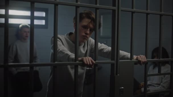 Prisioneiros Adolescentes Multiculturais Atrás Barras Metal Cela Prisão Olham Para — Vídeo de Stock