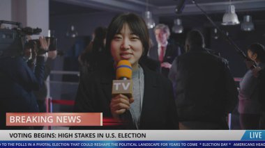 Asian female news anchor reports breaking news live on Election Day in the United States. Playback broadcast with running line for political TV program from press conference with American politician. clipart