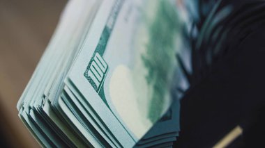 Döviz veya yatırım için 100 dolarlık banknotları sayan para sayma makinesini kapatın. Kağıt para için otomatik sayım ekipmanı. 100 dolarlık banknotlar. Finans ve bankacılık kavramı.