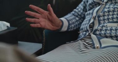 Psikoterapist muayenehanesinde el kol hareketi yapan yaşlı kadın hastaya yakın çekim. Yaşlı bir kadın zihinsel sorunları tartışıyor, terapiste endişeli hastalık deneyimini anlatıyor. Psikoloji konsepti. Portre.
