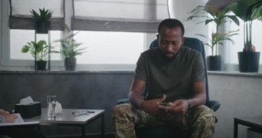 Travma sonrası stres bozukluğu olan Afrika kökenli Amerikalı asker psikologla konuşuyor, terapi seanslarında travmatik deneyimleri paylaşıyor. Kadın terapist askeri adamı dinler, notlar alır. Travma sonrası stres bozukluğu..