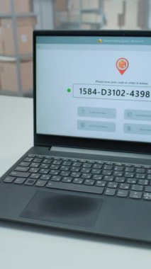 Tarayıcı ile karton kutunun üzerindeki Envanter Yöneticisi Tarama Kodunun Kapanışı, Paket Kontrol ediliyor. Dizüstü bilgisayar, E-Ticaret Siparişleriyle Paketi İzleme Uygulamasını Gösteriyor. Dikey Çekim.
