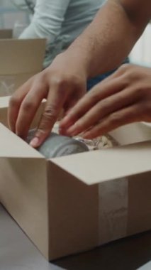 Close Up of Diverse Postal Workers, Shipping Clerks Packing Cardboard Parcels with Online Orders, Scanning Code, Preparing Packages for Delivery. Warehouse Facility, Sorting Center of E-Commerce Store