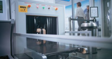 Security Checkpoint in Airport Terminal: Passenger Places Suitcase on Conveyor Belt for Luggage Screening for Boarding Plane Flight. Advanced X-ray Scanning Technology. Tourist Going on Vacation Trip. clipart