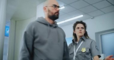 Havaalanı Terminali Güvenlik Kontrol Noktası: Afro-Amerikan Güvenlik Subayı X-ray taramasından sonra metal dedektörü kullanan adamı denetliyor. TSA tarama prosedürleri. Turist Tatile Çıkıyor.