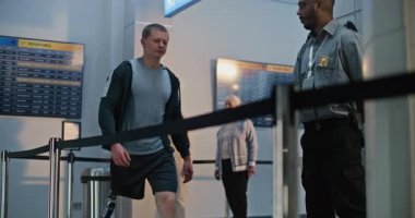 Güvenlik Kontrol Noktası: Havaalanı Terminali 'nde biyonik protez bacaklı bir adam X-ray metal dedektöründen geçiyor. Uçağa binmek için yolcu tarama prosedürleri. Engelli Yolcu.