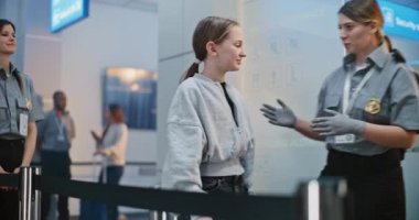 Güvenlik İşçisi, Genç Kız 'la birlikte havalimanı Terminalindeki güvenlik kontrol noktasına yürüyor. Kadın havaalanı görevlisi, uçağa binmek için kızı kontrol ediyor. Genç Gezgin Tatile Çıkıyor.