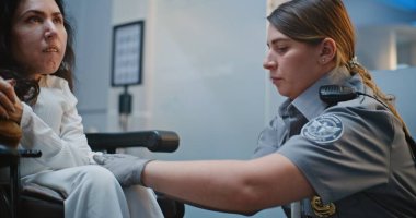 Güvenlik Kontrol Noktası: Havaalanı Terminali 'nde Engelli Kadın TSA Memurunun Kapanışı. Uçağa binmek için yolcu tarama prosedürleri. Tekerlekli sandalyedeki gezgin Seyahate çıkıyor.