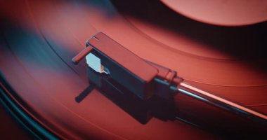 Vinil Plak Spinning On Vintage Turntable, Klasik Müzik veya Otantik Analog Müzik. Vinil Plak Oynatıcı, Nostaljik Atmosferli Retro Ses Sistemi. Kırmızı Neon Işıklandırma. Makro Yakın Çekim.