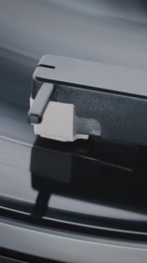 Klasik Turntable 'da Vinil Plak Dönüşü. İğne Usulca Tırmalama Merdiveni, Vinil Plak Çalarken Müzik. Nostaljik Atmosferli Klasik Ses Sistemi. Makro Yakın çekim. Dikey Çekim.
