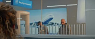 Havaalanı kontrol gişesi: Uluslararası Havaalanı Terminali 'ndeki Genç Adam' ın Kapanışı, Turist Veren Belgeler ve Uçak Biletleri Ajanı. Uçuş için pasaport kontrolü sırasındaki yolcular.