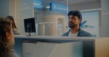 Havaalanı kontrol gişesi: Hintli Adam Yüz Tanıma Taramasıyla Biyometrik Verileri Doğrulayarak Havayolu Ajanı 'na Belge ve Uçak Biletleri Veriyor. Uluslararası Havalimanı Terminalinde Pasaport Denetimi.