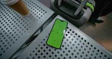 Havaalanı Terminali 'ndeki Havayolu Hub Lounge: Yeşil Kroma Anahtarlı Cep Telefonu Kahve ve Bavul' un yanındaki koltukta yatan Mock Up Görünümü. İş Reklamcılığı için Yer Tutucu ile Görüntü Şablonu. El bilgisayarı.