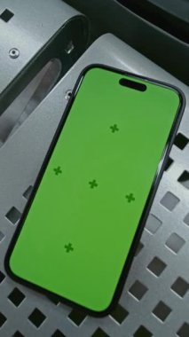 Havaalanı Terminali 'ndeki kalkış salonu: Yeşil Krom Anahtarlı Cep Telefonu Mock Up' ı Kahve ve Bavul 'un yanındaki koltukta yatarken görüntüle. İş Reklamcılığı için Yer Tutucu ile Görüntü Şablonu. Dikey Çekim