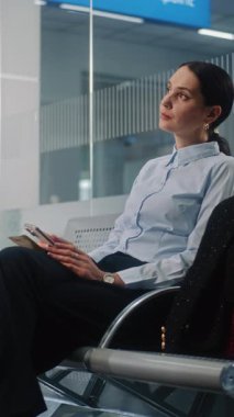 Havaalanı Terminali: Kadın Girişimci İş Gezisine Gidiyor. Başarılı İş Kadını Akıllı Telefon Kullanıyor, E-İş Yapıyor, Kalkış Salonunda Uçak Uçuşu Bekliyor. Ağır çekim. Dikey Çekim.