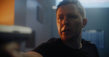 Epic Action Movie Scene: Black Taktik Giyimli Yorgun Erkek Suçlu Ağır Nefes alıyor, Silahı doğrultuyor, Düşmanla Konuşuyor. Karanlık Ofis Binası 'nda Gangster Saldırısı Tanınmayan Kişi.