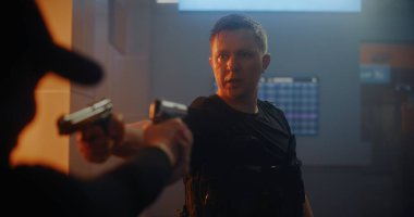 Silahlı Karşılaşma: Taktik Ekipman 'daki iki suçlu birbirine silah doğrultup konuşuyor. Memur Karanlık Ofis Binasında Cinayet Masası 'nda. Epic Action Movie 'den Gergin ve Dramatik Sahne.