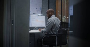 Çağrı sırasında borsa komisyoncusu bağırıyor, finansal zarara uğruyor, gerçek zamanlı hisse senedi ve borsa çizelgelerini takip ediyor. Afrika-Amerika Yatırım Ajanı Kötü Ekonomi Haberleri Hakkında Öfkeli.