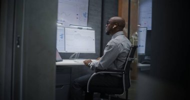 Telsiz Kulaklık Borsası İşlemcisi Gerçek Zamanlı Hisse Senedi İzleme, Çoklu İzleme Masası 'ndaki Borsa Çizelgeleri. Afrika-Amerika Yatırım Ajanı Geceleri Ofiste Çalışıyor.