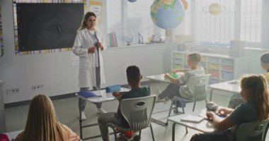 Kadın Sağlığı Profesyoneli Konuşuyor ve Meraklı Genç Öğrencilere Tıp Dersi Veriyor. Çocuklar el kaldırıyor, İlkokulda Sağlık ve Hijyen Dersinde Doktora Soru Soruyor.