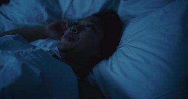 Genç Asyalı Kadın Gece Uyanık Kaldı, Uyuyamadı. Kız rahatsız edici bir şekilde vardiya alıyor, Stres ve Endişeli Düşünceler tarafından bunaltılıyor. Uykusuzluk, Huzursuz Düşler, Zihinsel Gerilim, Yoksul Dinlenme.
