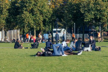Amsterdam - 02 Ekim 2022 Müzenin çimlerinde oturan öğrenciler.