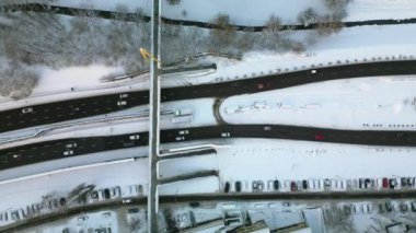 Aerial view of busy cars on highway road street and pedestrian bridge during winter in Krakow, Poland.
