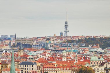 Zizkov Tower television in Prague in autumn. Traditional tile rooftops in foreground.