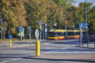 Modern trolley bus riding with passengers in the streets of Warsaw.