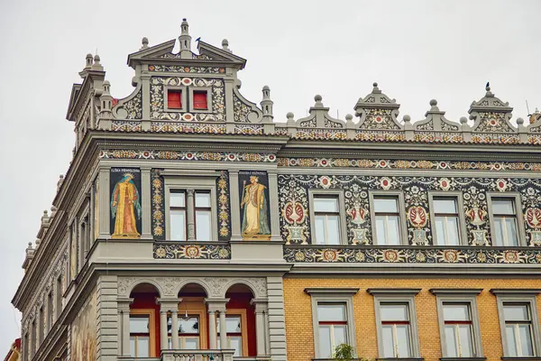 Beautifully decorated building in Prague. We see frescoes, ornaments and a religious theme.