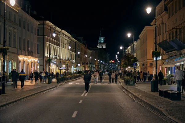 Main walking pedestrian street in Warsaw at night, Poland.