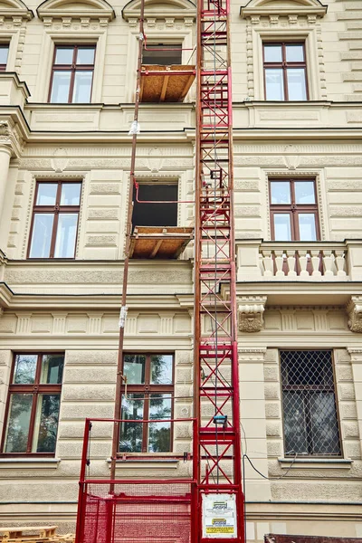 Facade of the historic building under reconstruction in Prague.