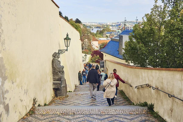Tourists are walking up the stairs in Prague, downtown, Czech Republic, European travel destination.
