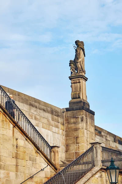 Statue on Charles Bridge in Prague against the sky.