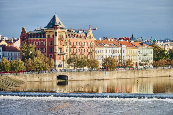 Historical buildings along the river Vltava in Prague in autumn.