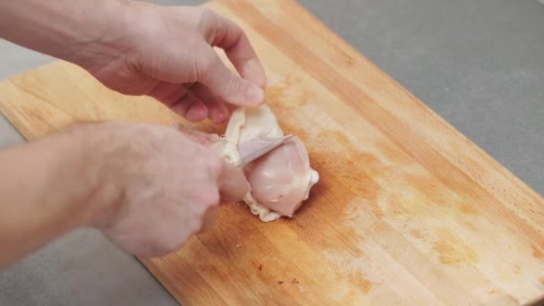 Man Removing Skin Chicken Leg Wooden Cutting Board — Stock Video