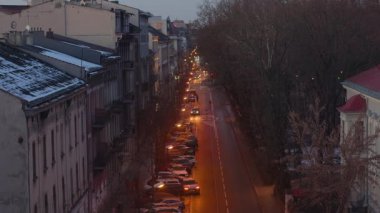 Eski şehir Krakow 'da, akşamları turuncu fenerler ve arabalarla..