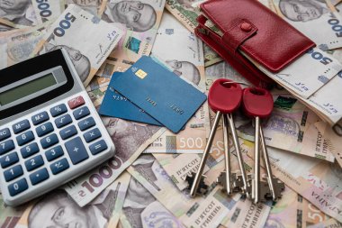business concept sale or rent home ukraine money uah gryvnia calculator credit card and purse, saving concept