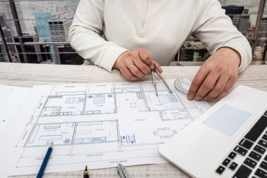 man throws sketches of drawings on paper with laptop. Designer makes sketches
