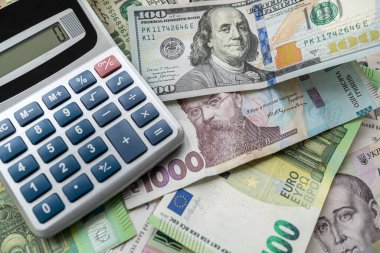 euro, dollars, hryvnia currency with calculator. Financial background. Money saving or exchange concept