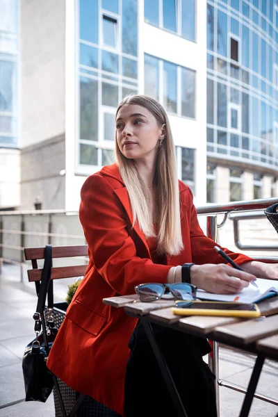 a stylish business woman works in a cafe during her lunch break. Concept of office work