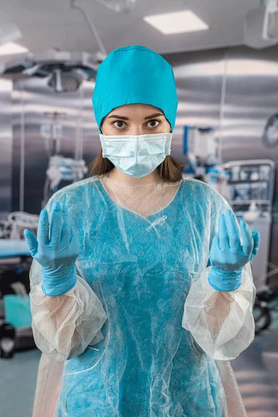 stock image pretty female medical worker in blue uniform alone in recovery room in hospital with stethoscope. medical concept