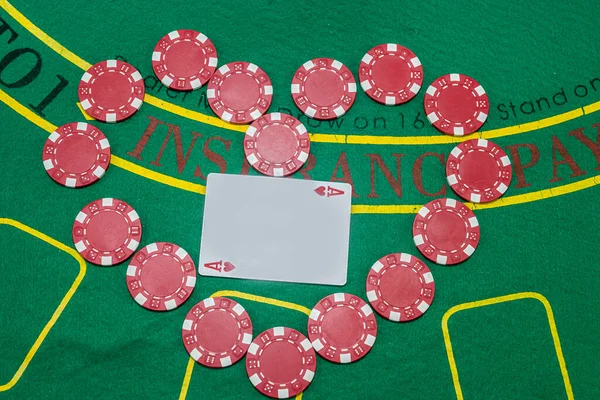 poker chips with playing cards scattered on a green casino table. Gambling. games for the company. excitement.